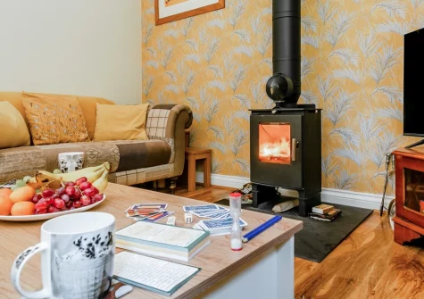 Buzzards Cottage, Redruth is a cosy two-bedroom retreat backing onto woodland, just three miles from Portreath beach, featuring a crackling wood burner, private garden terraces, and easy access to Cornwall's coastal paths and mining trails.