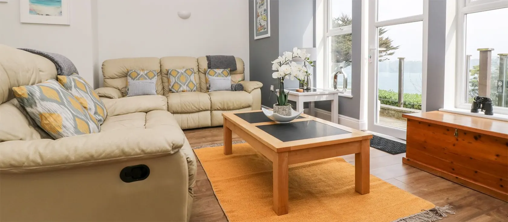 By the Sea, Newquay is a stylish two bedroom, two bathroom apartment in a Victorian property with electronic gates & mature gardens. The open living space flows onto the furnished terrace with sea views. Walk to harbour, beach, cafes & shops.