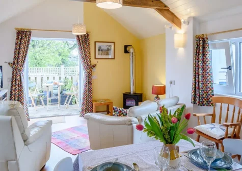 Byeways, Ashwater is a delightfully converted barn on the Devon and Cornwall border, offering rural charm and modern comfort. Explore Dartmoor and coastal beaches from your private garden. Perfect for families seeking a countryside escape.