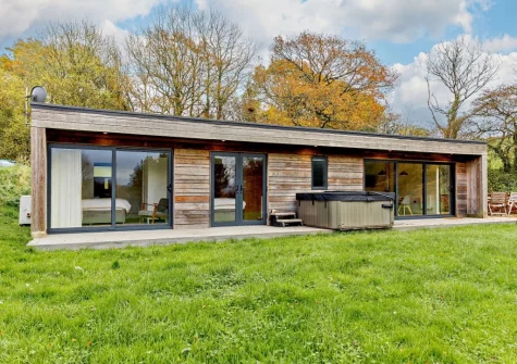 The decked terrace, hot tub & lawn at Cabana Lakeside Lodge 4, Whitnage