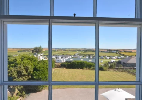The garden & far reaching countryside views from bedroom #1 at Carnevas Farmhouse, Porthcothan