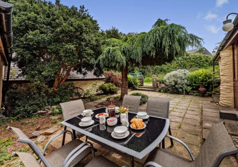 The enclosed patio garden & alfresco dining area at Cart Linhay Cottage, Bittadon