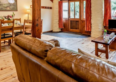 Cart Linhay Cottage, Bittadon is a beautifully converted stone barn on a 20-acre working farm, offering a private enclosed garden, on-site activities, and easy access to Woolacombe's golden beaches and Exmoor's dramatic landscapes.