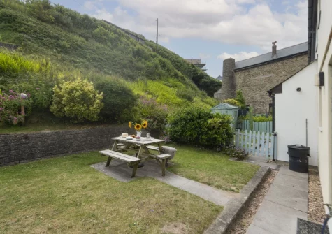 The patio, alfresco dining area & rear south-west facing garden at Castaways, Porthtowan