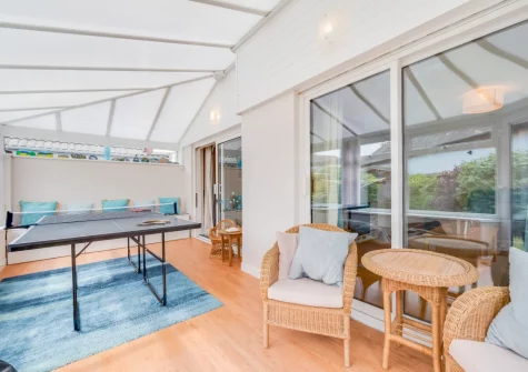 The sunny conservatory, with sitting area & table tennis, at Castaways, St Merryn