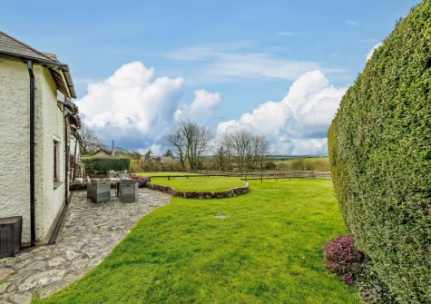 The patio, alfresco dining area & expansive garden at Cedar Cottage, Woolsery