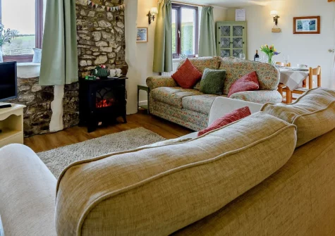 Cedar Cottage, Woolsery is a charming two-bedroom rural retreat set in peaceful North Devon countryside, featuring exposed beams, a lovely garden with wildlife ponds, spectacular views, and tranquil surroundings perfect for countryside escapes.