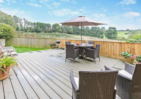 The decked patio, barbecue, alfresco dining area & enclosed garden at Cedar, Goldenbank