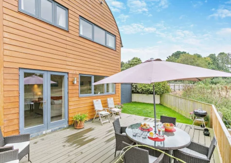 The decked patio, barbecue, alfresco dining area & enclosed garden at Cedar, Goldenbank