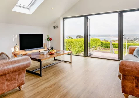 Cedar Lodge, Carbis Bay is a stunning 4-bedroom reversed-level home with breathtaking sea views. Enjoy contemporary elegance, spacious living areas, and a sun deck that's perfect for al fresco dining, all near St Ives' beaches and galleries.