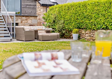 The patio, outdoor sitting area & garden at Cedar Lodge, Carbis Bay