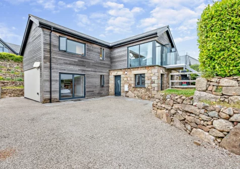 Cedar Lodge is an elevated reversed-level home with breath-taking views