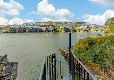 A spiral metal staircase at bottom of the garden offers access to an idyllic small beach during low tide