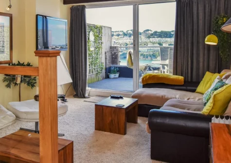 Chapel Retreat, Polruan is a characterful three-storey cottage in peaceful Polruan village, featuring a spectacular roof terrace with panoramic River Fowey views, contemporary interiors, and private parking, moments from the beach and ferry to Fowey.