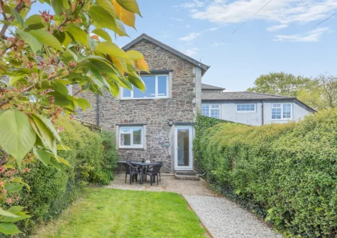 The patio, alfresco dining area & enclosed garden at Cherry Cottage at Mettaford Farm, Hartland