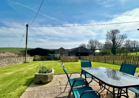 The patio, barbecue, alfresco dining area & enclosed garden at Cherry Cottage, St Issey