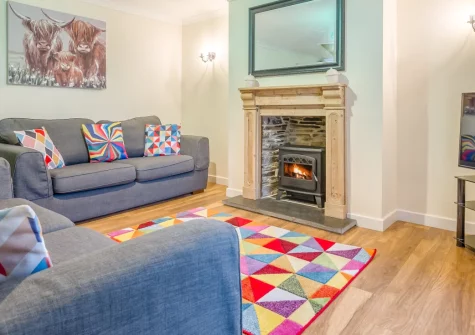 Cherry Cottage, St Issey is a charming stone-built retreat on a working sheep farm in North Cornwall, featuring contemporary interiors, an enclosed garden with countryside views, and easy access to the dramatic coastline and Camel Trail.