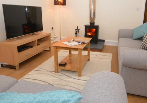 Cherry Tree Barn, Alwington is a stylish single-storey conversion set in peaceful Devon countryside, featuring a private hot tub, sunny enclosed garden, cosy woodburner, and countryside walks from the door, close to North Devon's beaches.