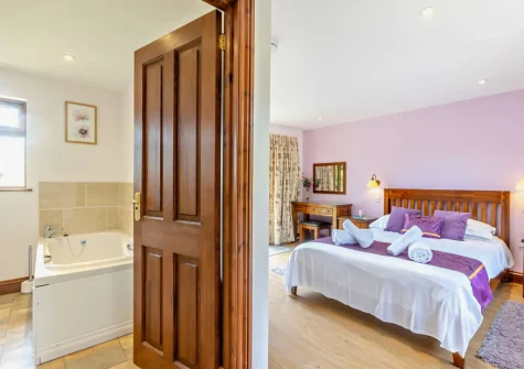 The bedroom & en-suite bathroom at Cherry View, South Molton