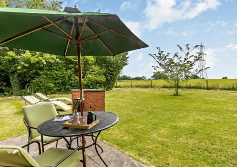 The rear patio, barbecue, alfresco dining area & garden at Cherry View, South Molton