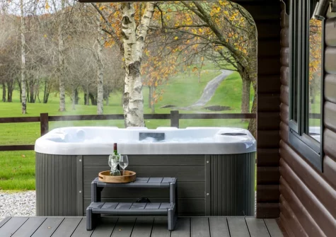 The alfresco dining area & hot tub at Chestnut, 6 Fingle Glen Lodges, Pathfinder Village