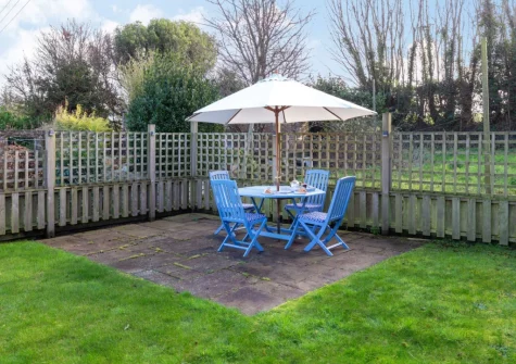 The enclosed rear garden, patio, barbecue & alfresco dining area at Christopher Cottage, Lanteglos