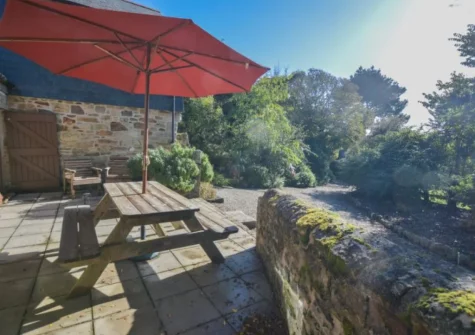 The south-facing patio, barbecue & alfresco dining area at Church Close Cottage, Cusgarne