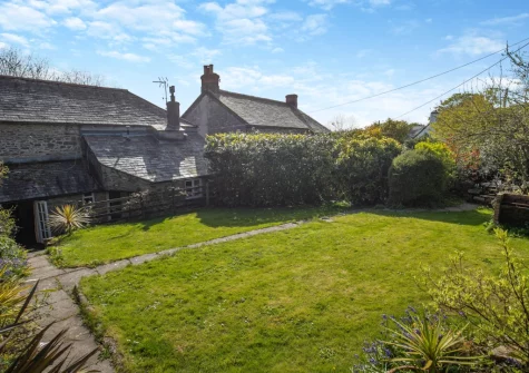 The enclosed raised garden, with barbecue & alfresco dining area, at Churchtown Cottage, Blisland