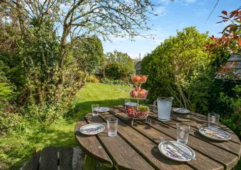 The enclosed raised garden, with barbecue & alfresco dining area, at Churchtown Cottage, Blisland