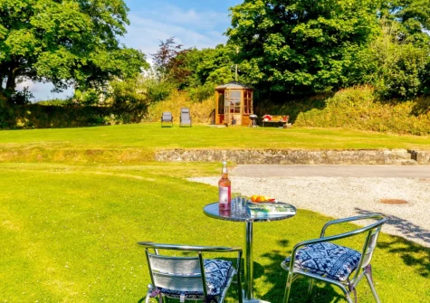 The enclosed garden, outdoor sitting area & summer house at Churn Cottage, Bokiddick