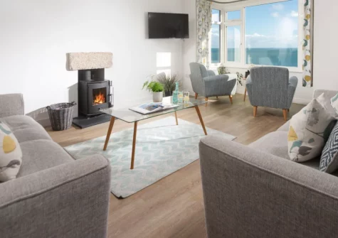 Chy an Mor, Coverack is a former coastguard cottage sleeping eight, with captivating sea views from nearly every room. Enjoy a cosy wood-burner, a sun-soaked slate terrace, and the coast path right on your doorstep; perfect for families and groups.