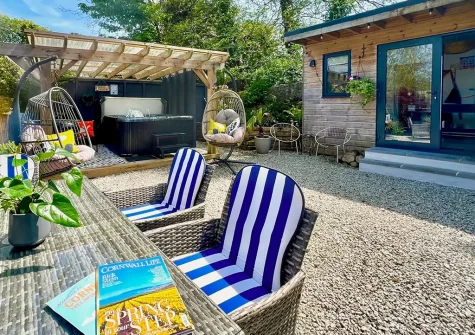 The alfresco dining, outdoor sitting area & hot tub at Chy Bian, Lanner