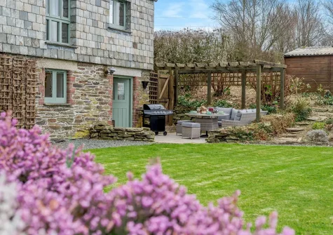 The patio, barbecue, outdoor sitting area & garden at Chy Kerensa, Trewidland