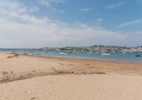 Instow Beach is famous for its calm, shallow waters, expansive low-tide sands & stunning views of the colorful fishing village of Appledore