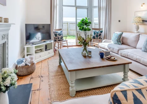 Cleveland Villa, Instow is a spacious five-bedroom retreat just steps from the sandy beach where rivers meet sea, featuring balconies with estuary views, contemporary coastal interiors, and the renowned Tarka Trail winding past your door.
