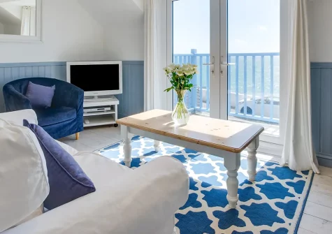 Cliff Top Cottage, Porthleven is a stylish two-bedroom seaside sanctuary with sublime sea views, New England charm, and direct access to a picturesque harbour and beach. Create cherished family memories in this enchanting coastal retreat.