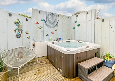 Unwind under the star lit sky in the hot tub at Coastal Dreams, St Ives