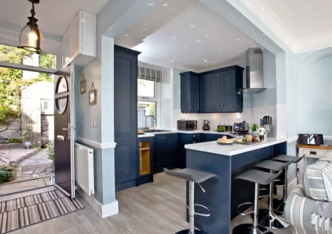 The kitchen with breakfast bar at Coastguard Cottage, Dawlish