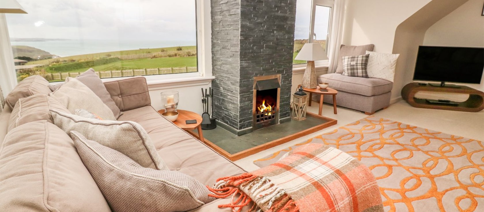 Coastman's Nest, Mawgan Porth is a four bedroom luxury holiday home for eight with superb sea views from the bright living room & garden. Hypnos beds, an open fire, drying room, picture windows & off-road parking make this a top choice for off-season breaks.
