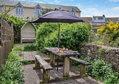 The enclosed sunny courtyard garden & alfresco dining area at Cockle Cottage, Appledore