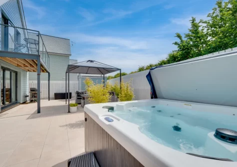 The patio, outdoor sitting area & hot tub at Coco Beach, Westward Ho!