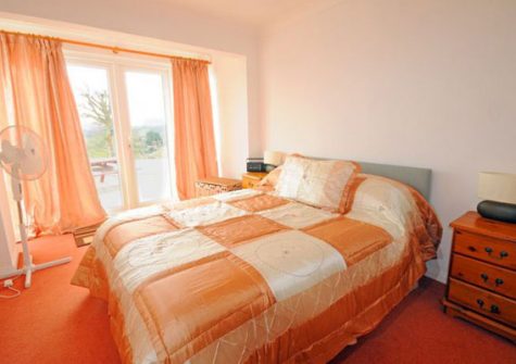 Bedroom #1 @ Collingwood features doors opening out onto the gardens