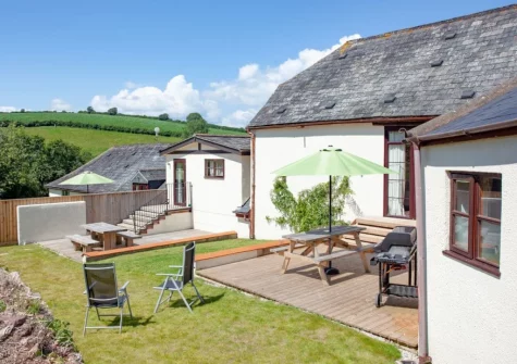The patio, barbecue, alfresco dining area & enclosed garden at Columbia at Ashcombe Cottages, Ashcombe