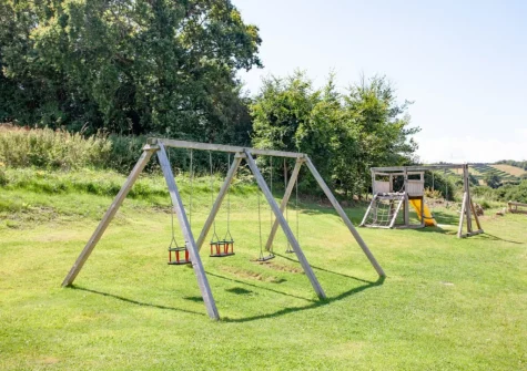 The shared children's outdoor play area at Ashcombe Cottages, Ashcombe