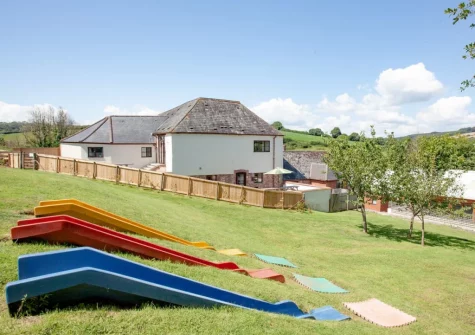The shared children's outdoor play area at Ashcombe Cottages, Ashcombe