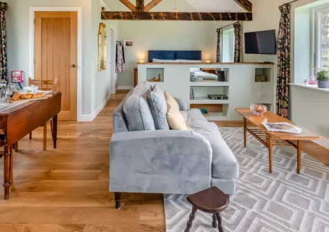Combes Barn, Greencliff Farm, Abbotsham is a delightful single-storey studio barn conversion with spectacular sea views, a cosy open-plan interior, a private enclosed garden, and direct access to North Devon's stunning coastal walks and beaches.