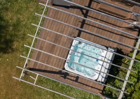 The raised decking area with sunken hot tub & outdoor shower at Coombe Rise, Poughill