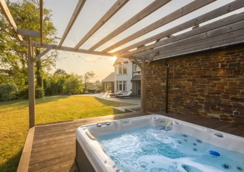 The raised decking area with sunken hot tub & outdoor shower at Coombe Rise, Poughill