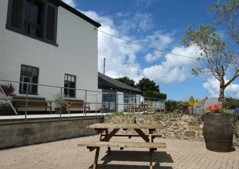 The shared outdoor sitting / alfresco dining area at Copperhouse View, Hayle
