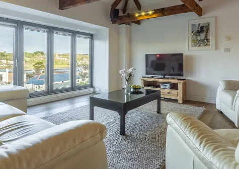 Copperhouse View, Hayle is a luxurious two-bedroom apartment set within a stunning listed building. Enjoy contemporary designer interiors, exposed beams, underfloor heating, and easy access to Cornwall's golden beaches and charming St Ives.